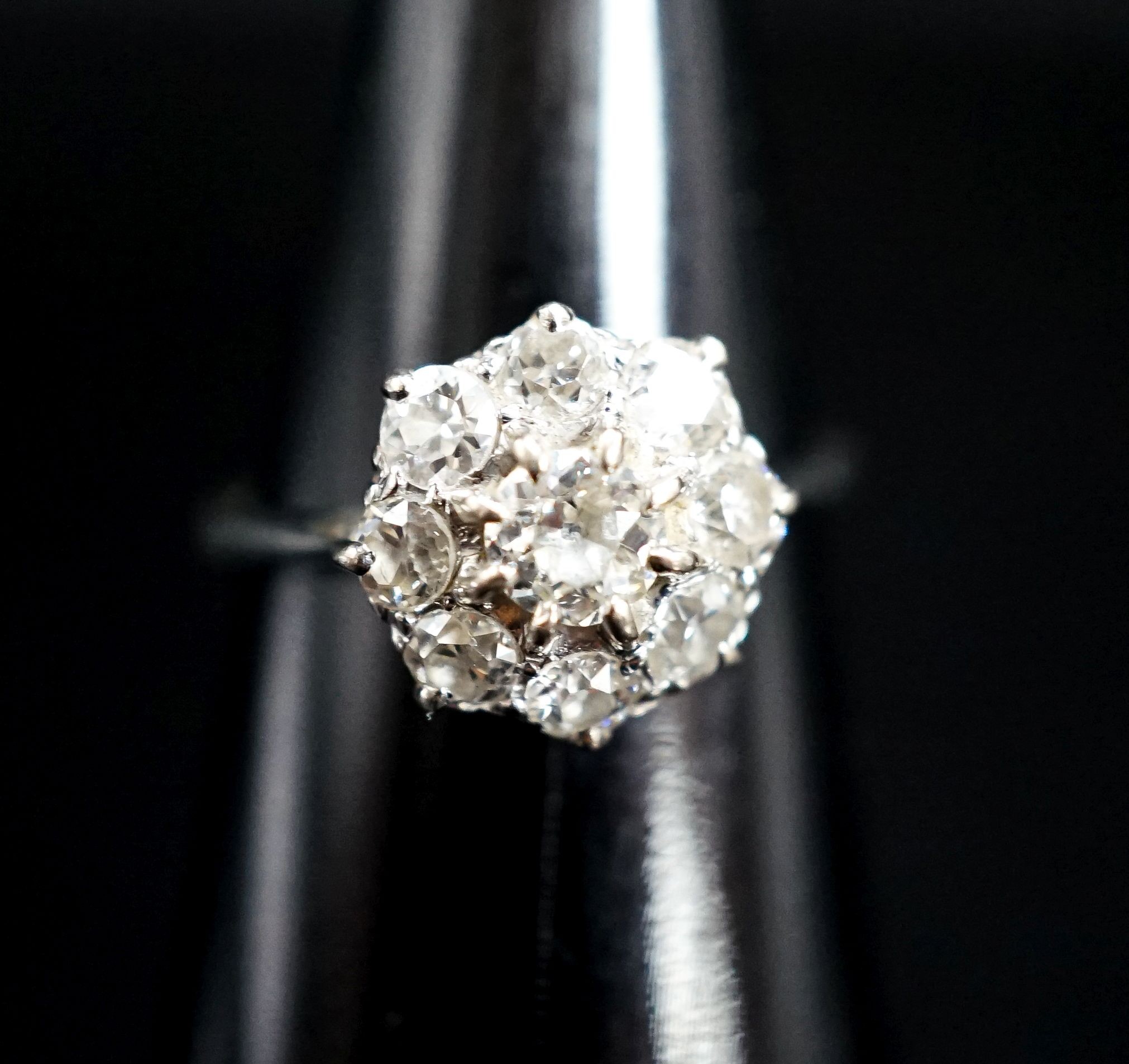 A white metal and diamond cluster ring, size J, gross 2 grams.